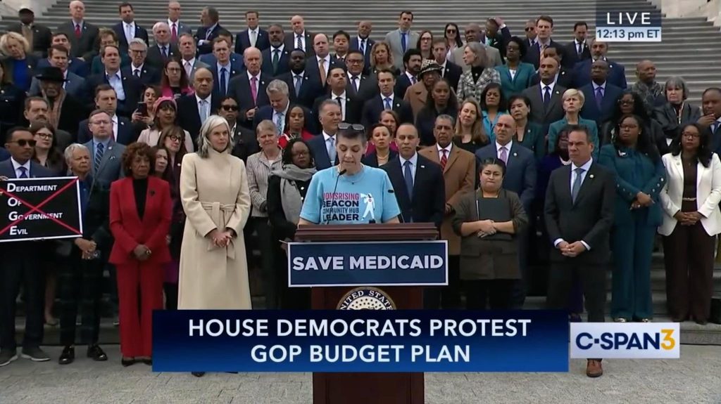 Mary Beth Cochran speaking before members of the House Democratic Caucus