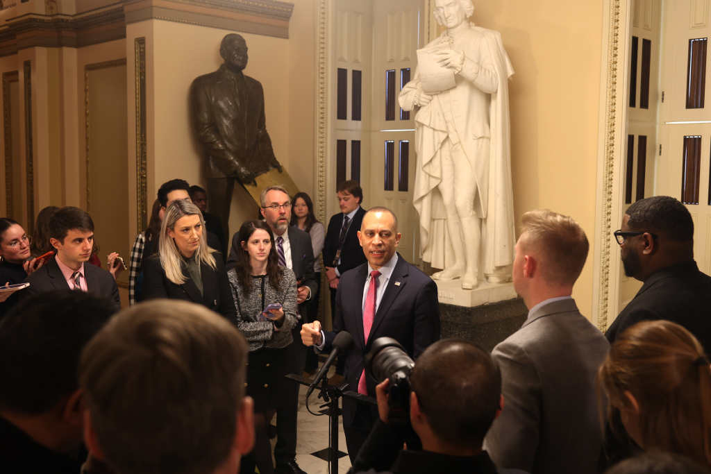 Leader Jeffries speaking at press conference near Will Rogers statue