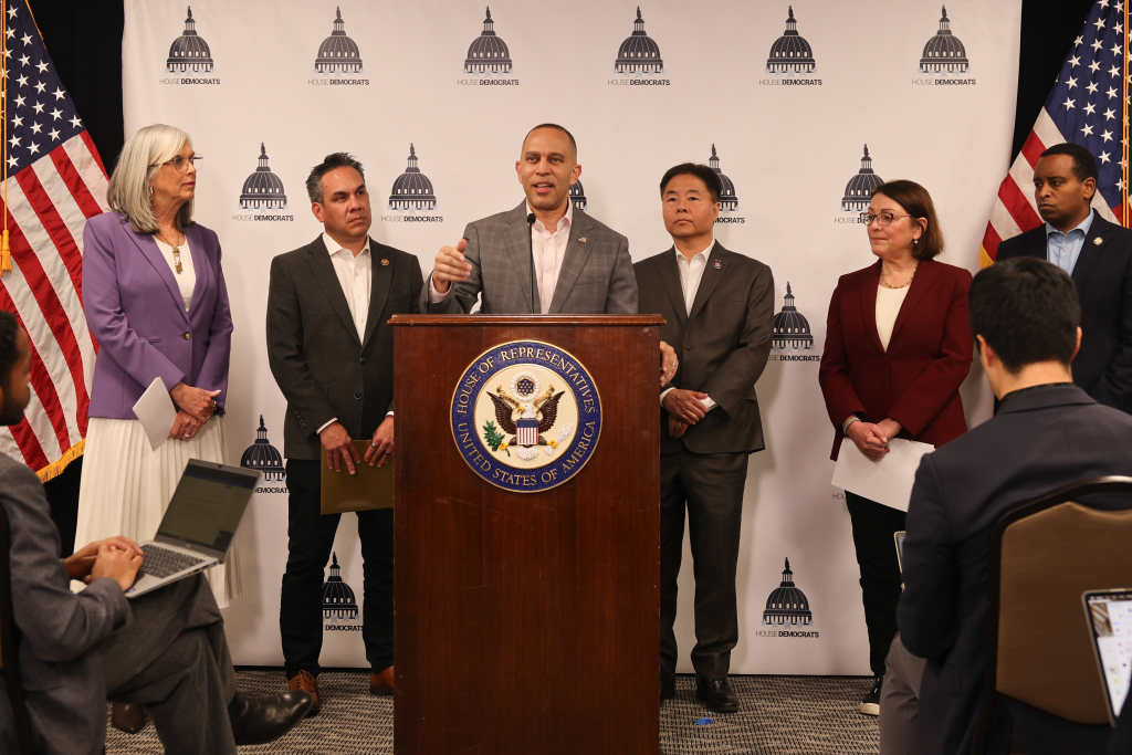 Leader Jeffries (center) speaking at press conference, joined by (left to right) Democratic Whip Katherine Clark, Democratic Caucus Chair Pete Aguilar, Democratic Caucus Vice Chair Ted Lieu, DCCC Chair Suzan DelBene, Assistant Democratic Leader Joe Neguse