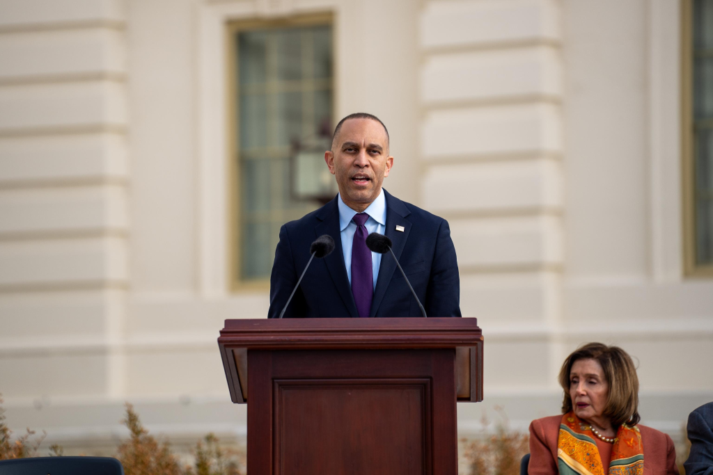 Leader Jeffries speaking from a podium at the Upper West Terrace of the US Capitol